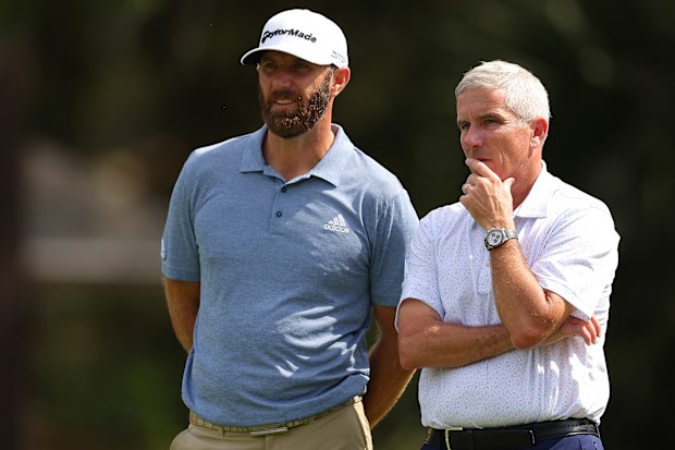 Jay Monahan converses with Dustin Johnson.