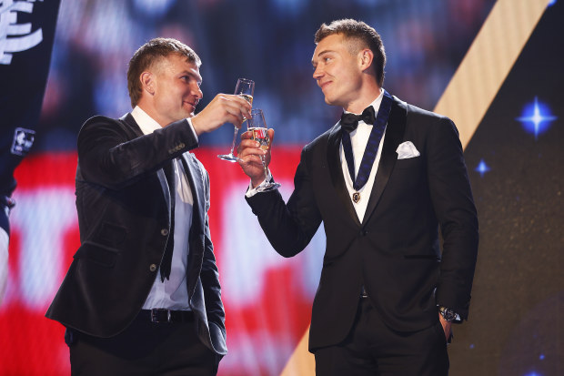 Patrick Cripps is congratulated by Ollie Wines of the Power after winning the Brownlow Medal.
