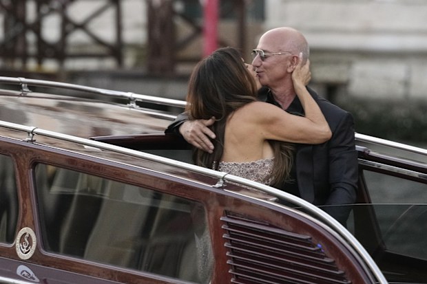 Lauren Sanchez Bezos, left, kisses Jeff Bezos as they depart from the Aman hotel during wedding celebrations in Venice, Italy, Saturday, June 28, 2025. (AP Photo/Luca Bruno)