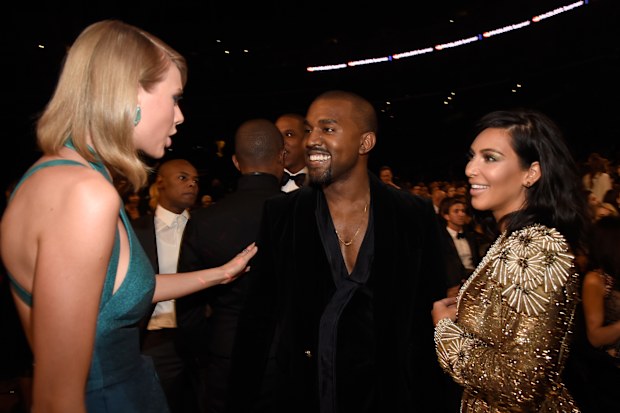 Kayne West, with then wife Kim Kardashian, and Taylor Swift at the 57th Annual GRAMMY Awards on February 8, 2015, where they made up six years after their feud. 