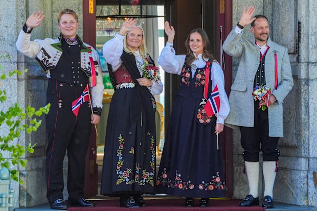 Norway's Crown Prince Haakon, Crown Princess Mette-Marit and their children Prince Sverre Magnus, left, and Princess Ingrid Alexandra, second left, greet the children's procession during the May 17 celebration at Skaugum in Asker, Norway, Saturday May 17, 2025. (Lise Aaserud/NTB via AP)