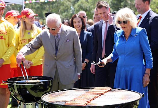 King Charles III and Queen Camilla cook sausages for the food stalls at the Premier's Community Barbeque at Parramatta Park on October 22, 2024 in Sydney, Australia. The King's visit to Australia is his first as monarch, and the Commonwealth Heads of Government Meeting (CHOGM) in Samoa will be his first as head of the Commonwealth.