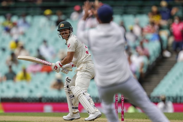 Australia's David Warner watches as he hits the ball to India's Cheteshwar Pujara to be out caught for 5 off Mohammed Siraj.