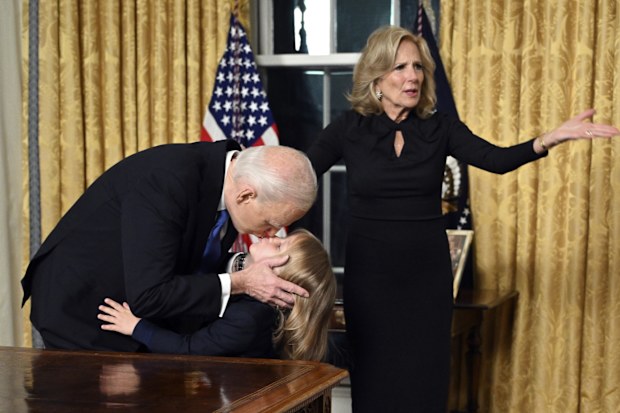President Joe Biden kisses his grandson Beau Biden as first lady Jill Biden gestures after giving his farewell address from the Oval Office of the White House Wednesday, Jan. 15, 2025, in Washington. (Mandel Ngan/Pool via AP)
