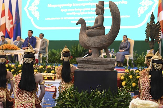 The 10th-century statue of Skanda atop a peacock, upper, is displayed during a handing over ceremony at Peace Palace, in Phnom Penh, Cambodia, Friday, March 17, 2023. 