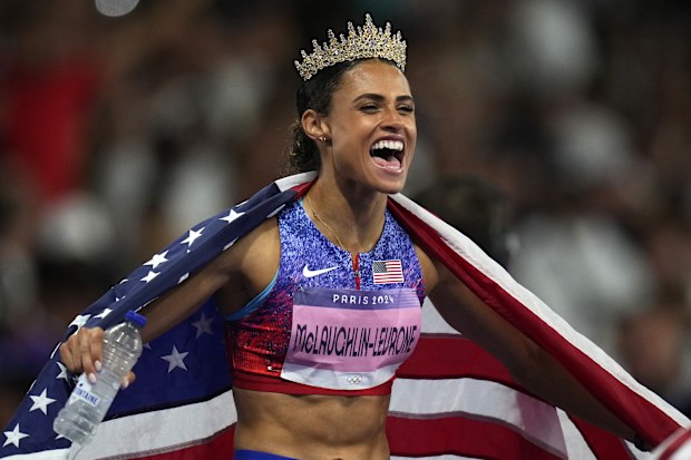 Sydney McLaughlin-Levrone receives a crown from her sister-in-law. 