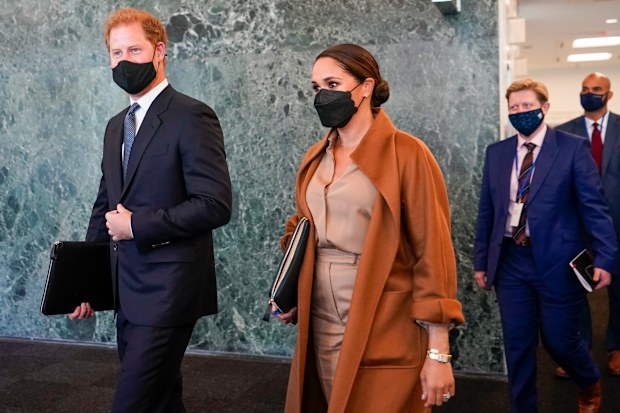 Prince Harry and Meghan, the Duke and Duchess of Sussex are escorted as they leave the United Nations headquarters after a visit during 76th session of the United Nations General Assembly, Saturday, Sept. 25, 2021. (AP Photo/Mary Altaffer)