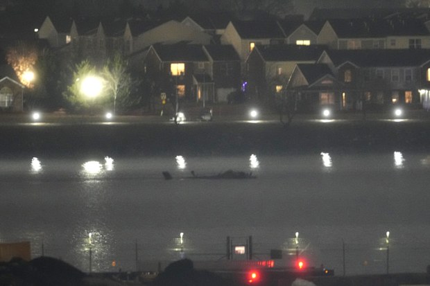 The wreckage of a Black Hawk helicopter is pictured in the Potomac River from Ronald Reagan Washington National Airport, Friday, Jan. 31, 2025, in Arlington, Va. (AP Photo/Alex Brandon)