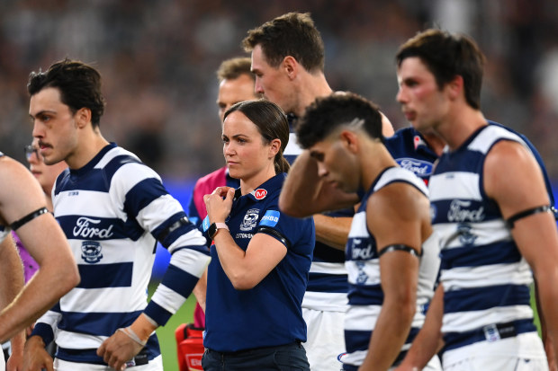 MELBOURNE, AUSTRALIA - MARCH 17: Daisy Pearce looks on as Cats head coach Chris Scott  speaks to his players  during the round one AFL match between Geelong Cats and Collingwood Magpies at Melbourne Cricket Ground, on March 17, 2023, in Melbourne, Australia. (Photo by Quinn Rooney/Getty Images)