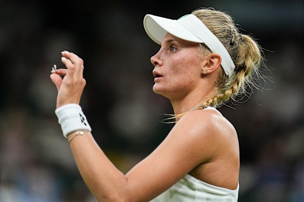 Dayana Yastremska of Ukraine picks up Coco Gauff's earring from the court during their Ladies' Singles First Round match on day two of The Championships Wimbledon 2025 at All England Lawn Tennis and Croquet Club on July 1, 2025 in London, England. 