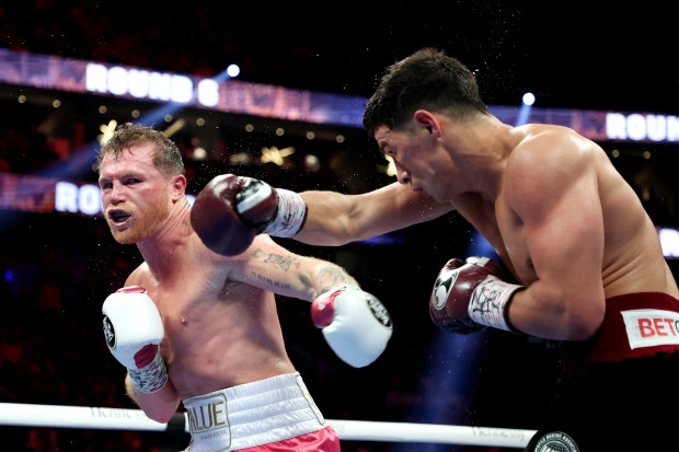 Canelo Alvarez (L) exchanges punches with Dmitry Bivol during their WBA light heavyweight title fight at T-Mobile Arena.