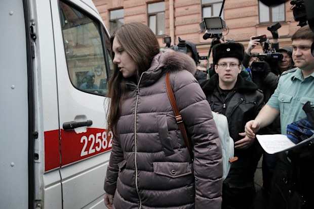 Alla Ilyina, who broke out of the hospital on Feb. 7 after learning that she would have to spend 14 days in isolation instead of the 24 hours doctors promised her, is escorted by a bailiffs form a court after a session in St.Petersburg, Russia, Monday, Feb. 17, 2020.A woman who escaped from a hospital in St. Petersburg, where she was being kept in isolation for possible inflection by the new coronavirus, was ordered by court on Monday to return back to the quarantine for at least two days.