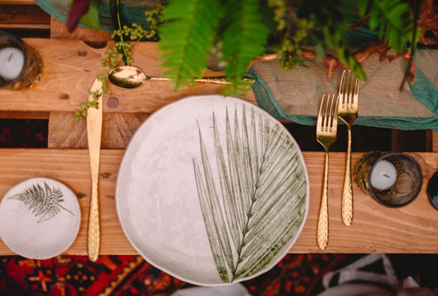 Stylish wedding table with candles, dishes and floristic. Wedding rustic dinner