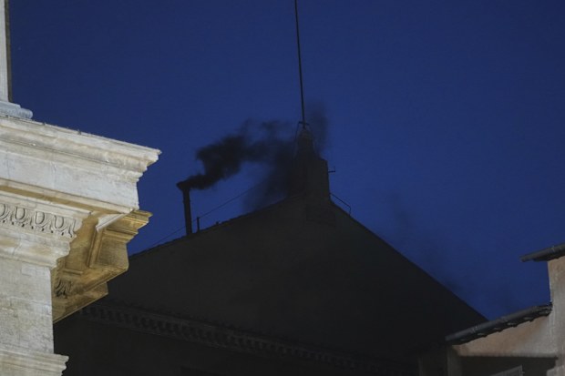 Black smoke billows from the chimney of the Sistine Chapel during the cardinals' conclave to elect a new pope, at the Vatican, Wednesday, May 7, 2025.