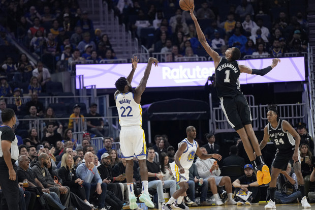 SAN FRANCISCO, CALIFORNIA - OCTOBER 20: Victor Wembanyama #1 of the San Antonio Spurs blocks the shot of Andrew Wiggins #22 of the Golden State Warriors during the first half of an NBA basketball game at Chase Center on October 20, 2023 in San Francisco, California. 