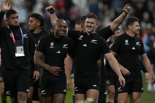 New Zealand's Mark Telea, (center left), and Dalton Papali'i celebrate after the Rugby World Cup semi-final match againt Argentina.