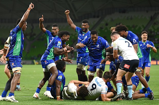 Fijian Drua celebrate scoring a try.