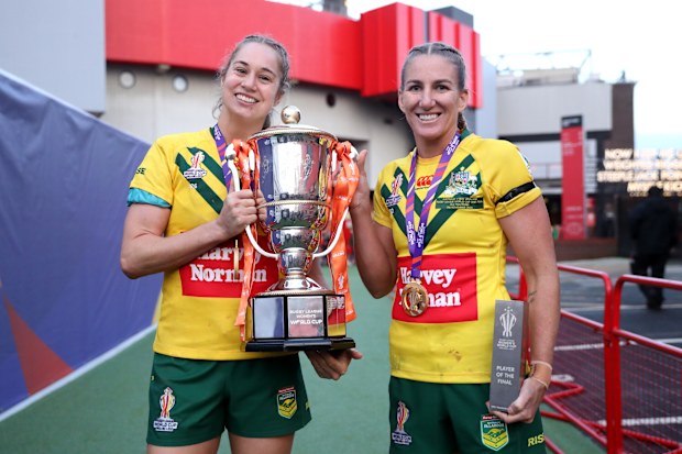 Kezie Apps and Ali Brigginshaw of Australia celebrate with the Women's Rugby League World Cup trophy and winners medals following the Women's Rugby League World Cup Final match between Australia and New Zealand at Old Trafford on November 19, 2022 in Manchester, England. (Photo by Charlotte Tattersall/Getty Images for RLWC)