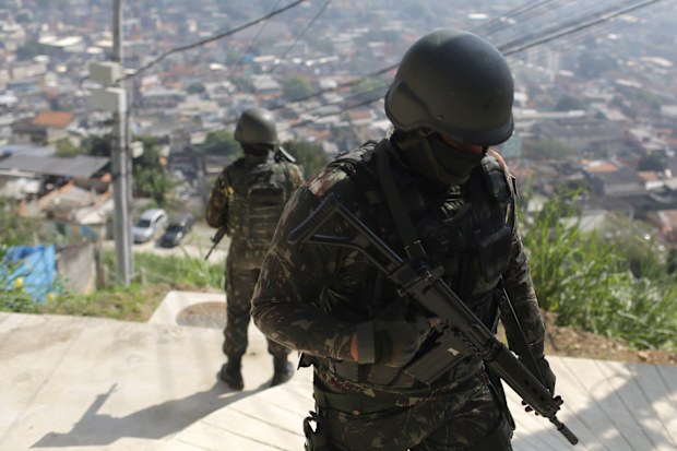 In August 2018, at least eight people died during an operation against crime in favelas, which was conducted by 4,200 soldiers of the Brazilian Army, with the support of the police.  EPA/ANTONIO LACERDA