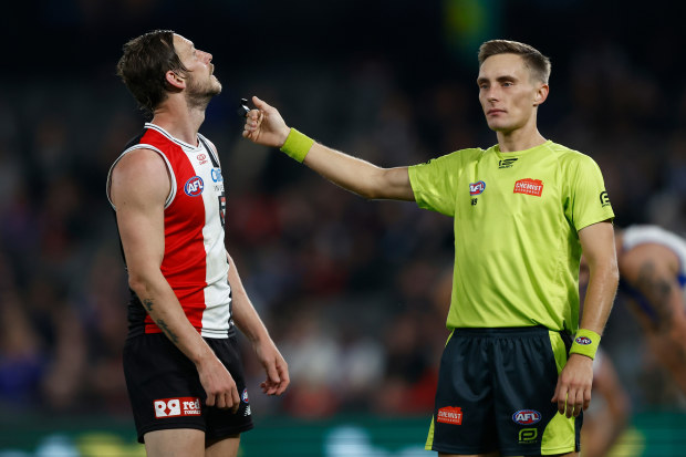 AFL Umpires are communicated to during games through their ear pieces.