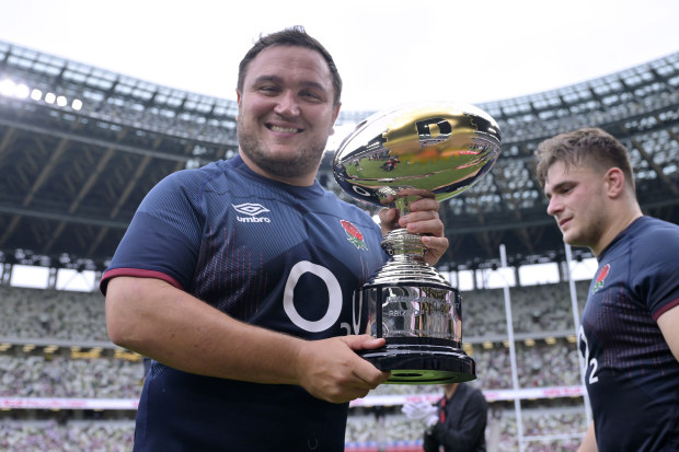 Jamie George of England poses with the trophy.