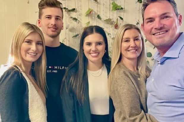 Lisa Mansfield with her husband (right) and two daughters (left and centre).