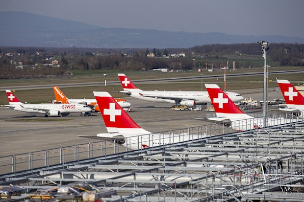 Swiss International Air Lines aircrafts and easyJet aircraft are parked on the tarmac of the Geneva Airport due to the coronavirus COVID-19.