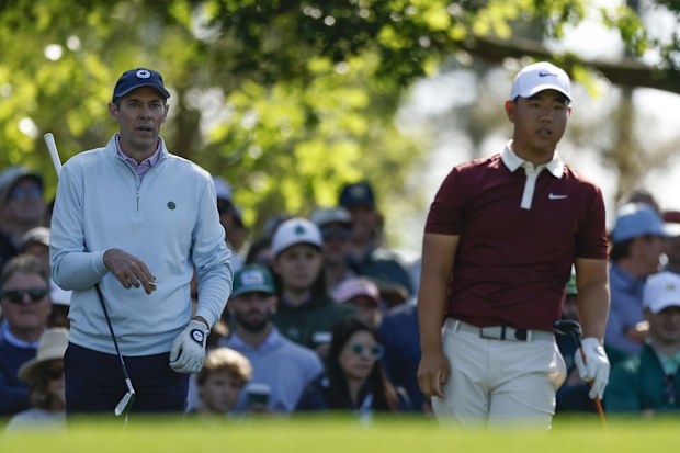The marker, Michael McDermott, and Tom Kim of Korea look on from the fourth tee during the third round of the 2025 Masters Tournament at Augusta National Golf Club on April 12, 2025 in Augusta, Georgia. (Photo by Harry How/Getty Images)