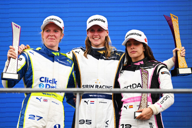 Beitske Visser (middle) with second placed Alice Powell (left) and third placed Marta Garcia (right) celebrate on the podium during the W Series at the Singapore Grand Prix.