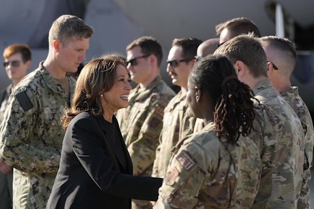 Democratic presidential nominee Vice President Kamala Harris greets members of the military near a C-17 cargo plane after receiving a briefing on the damage from Hurricane Helene.