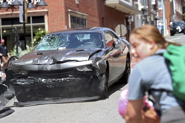 A vehicle reverses after driving into a group of protesters demonstrating against a white nationalist rally in Charlottesville, Virginia on August 12, 2017. The 2017 attack killed 32-year-old Heather Heyer and injured dozens of others. The car attack came after the rally had descended into chaos, with brawling breaking between white nationalists and counter-demonstrators. 