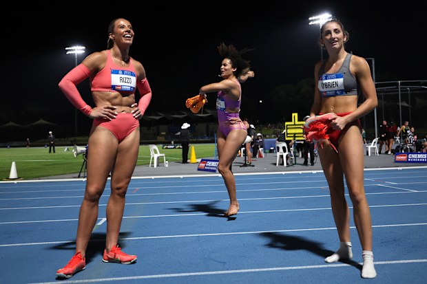 Torrie Lewis (centre) celebrates after a three-minute wait for the placings to be confirmed, as Bree Rizzo (left) and Leah O'Brien settle for the minor places.