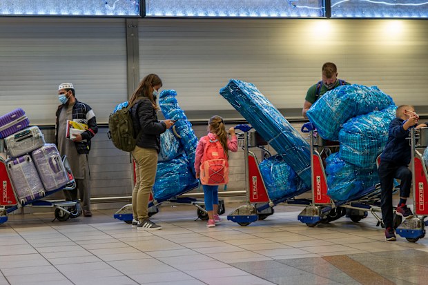 People lineup to get on an overseas flight at OR Tambos airport in Johannesburg, South Africa, Friday Nov. 26, 2021. 