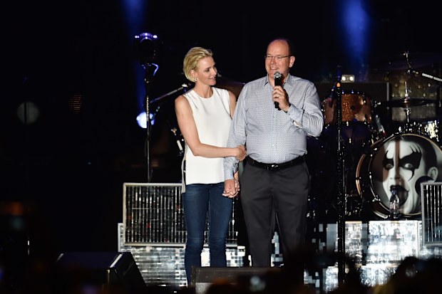 Prince Albert II of Monaco and Princess Charlene of Monaco speak onstage before the Robbie Williams concert during the Second Day of the 10th Anniversary on the Throne Celebrations on July 12, 2015 in Monaco, Monaco. (Photo by Stephane Cardinale/Corbis via Getty Images)