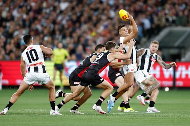 Nick Daicos of the Magpies handballs against St Kilda.