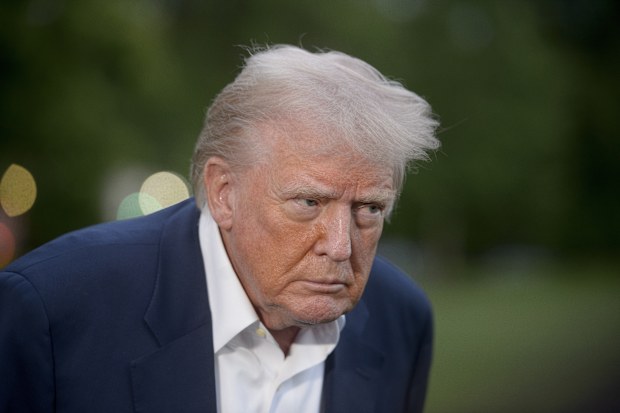President Donald Trump speaks with reporters after disembarking Marine One upon arrival on the South Lawn of the White House in Washington, Sunday, May 4, 2025. (AP Photo/Rod Lamkey, Jr.)
