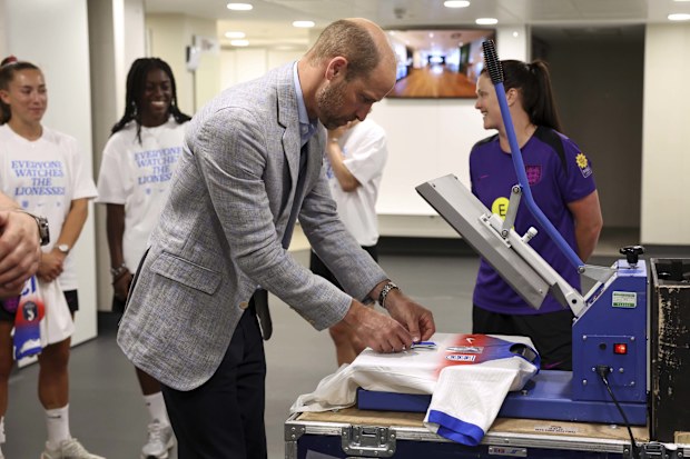 Britain's Prince William, the Prince of Wales, Patron of The Football Association, visits St. George's Park, England's national football centre, puts a number oin a shirt for printing as he meets with the England Women's team and wish them luck ahead of the 2025 UEFA Women's Euros competition in Burton on Trent, Monday, June 30, 2025.(AP Photo/Darren Staples, Pool)