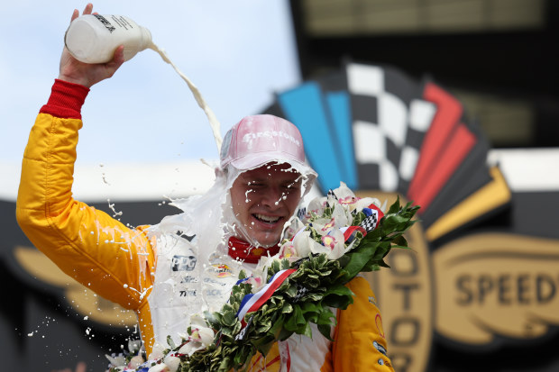 Josef Newgarden celebrates winning the Indianapolis 500 by pouring milk on his head after the 107th Running of Indianapolis 500.