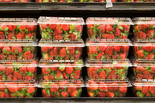 Strawberries in containers on supermarket shelf