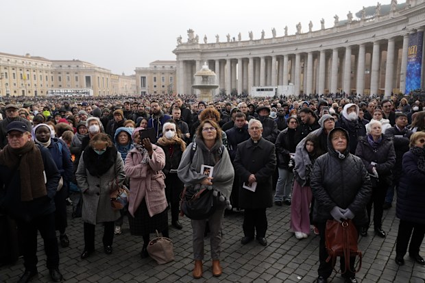 Faithful attend the funeral mass for late Pope Emeritus Benedict XVI in St. Peter's Square at the Vatican, Thursday, Jan. 5, 2023. 