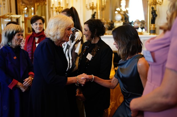 Queen Camilla greets Victoria Beckham