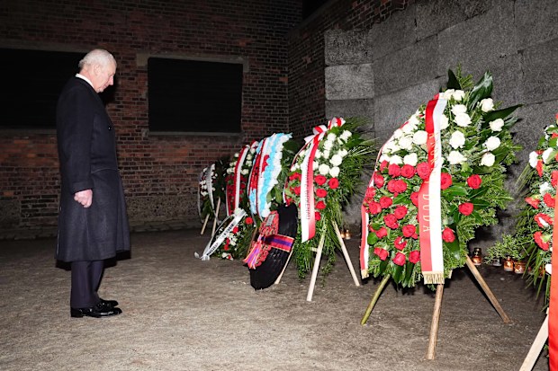 OSWIECIM, POLAND - JANUARY 27: King Charles III views floral tributes at 'The Death Wall' during a tour of Auschwitz-Birkenau in Poland, following commemorations to mark 80 years since the liberation of the concentration camp on January 27, 2025 in Oswiecim, Poland. The Nazis built and operated the Auschwitz complex of concentration camps during World War II initially for slave labor and later for the mass extermination of Jews and other undesirables. Approximately 1.1 million people died at Aus