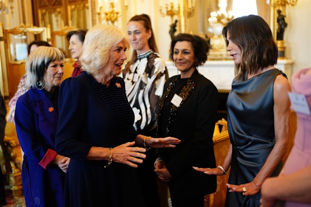 Queen Camilla greets Victoria Beckham