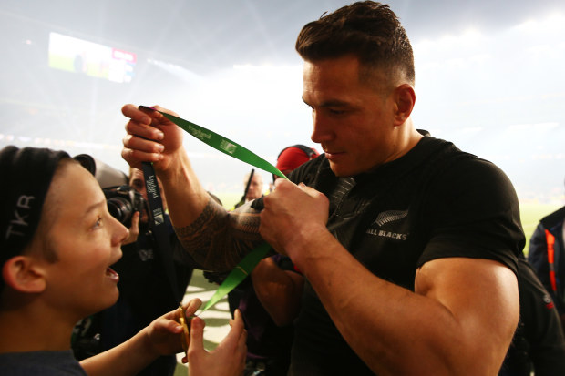 Sonny Bill Williams of New Zealand gives his winning medal to young fan Charlie Lines.
