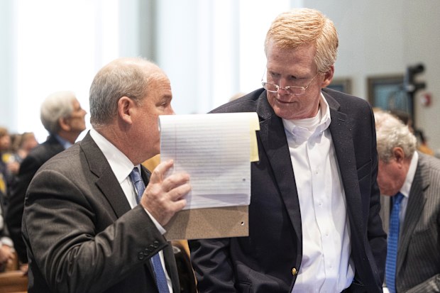 Alex Murdaugh, right, speaks with defense attorney Jim Griffin during a break in his trial for murder at the Colleton County Courthouse in Walterboro, S.C., on Wednesday, Feb. 15, 2023. The 54-year-old attorney is standing trial on two counts of murder in the shootings of his wife and son at their Colleton County, S.C., home and hunting lodge on June 7, 2021. (Joshua Boucher/The State via AP, Pool)