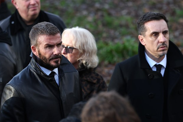 MANCHESTER, ENGLAND - DECEMBER 22:   Sir David Beckham & Gary Neville attend the funeral of Gary Mounfield, also known as Mani, at Manchester Cathedral on December 22, 2025 in Manchester, England. Mani is know for being the bass guitarist in rock bands The Stone Roses and Primal Scream. He died on November 20, 2025 at the age of 63 after suffering from a long-standing lung condition.  (Photo by Ryan Jenkinson/Getty Images)