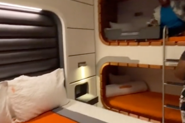 Carina Ja showing the bed and bunk beds or 'cubbies' in the cabin room.