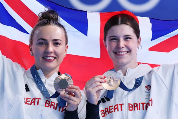 Bronze Medalists Andrea Spendolini-Sirieix and Lois Toulson of Team Great Britain pose with the national flag 