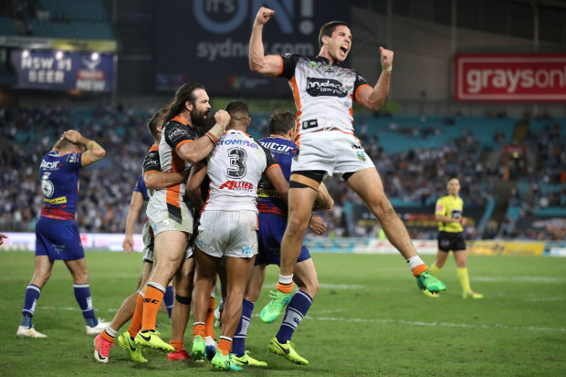 Aaron Woods, Michael Chee-Kam and Mitch Moses of the Tigers celebrates victory with his team during the round eight NRL match between the Wests Tigers and the Canterbury Bulldogs at ANZ Stadium on April 23, 2017 in Sydney, Australia.  (Photo by Mark Kolbe/Getty Images)