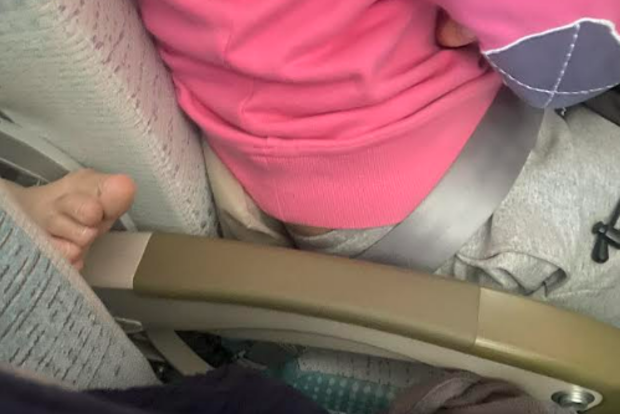 foot on armrest during emirates flight